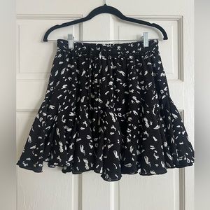 Skirt with built in shorts, elastic waist band and adjustable strings.